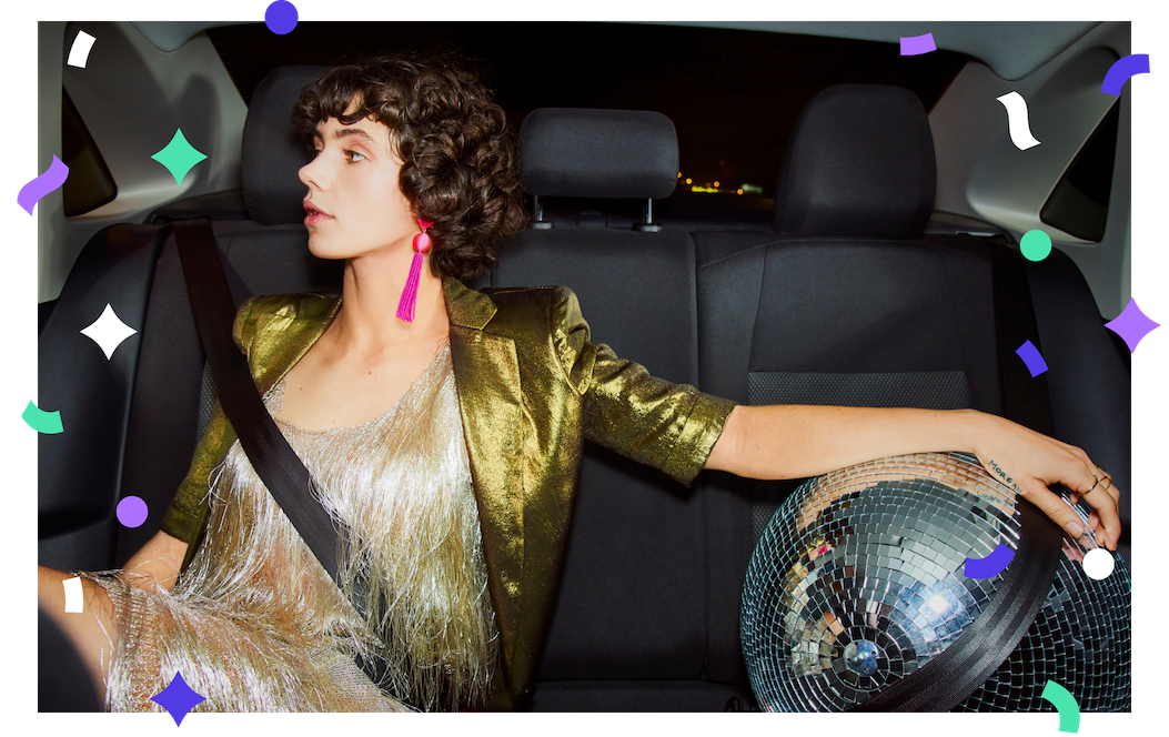 Woman on her way to a holiday party in the back of a Lyft ride.